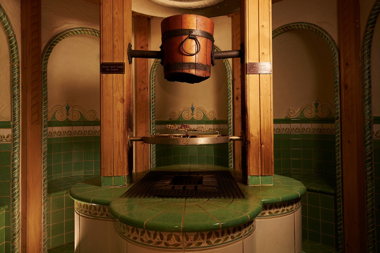 Greek Herbal Bath with individual tiled seating around a selection of herbs.